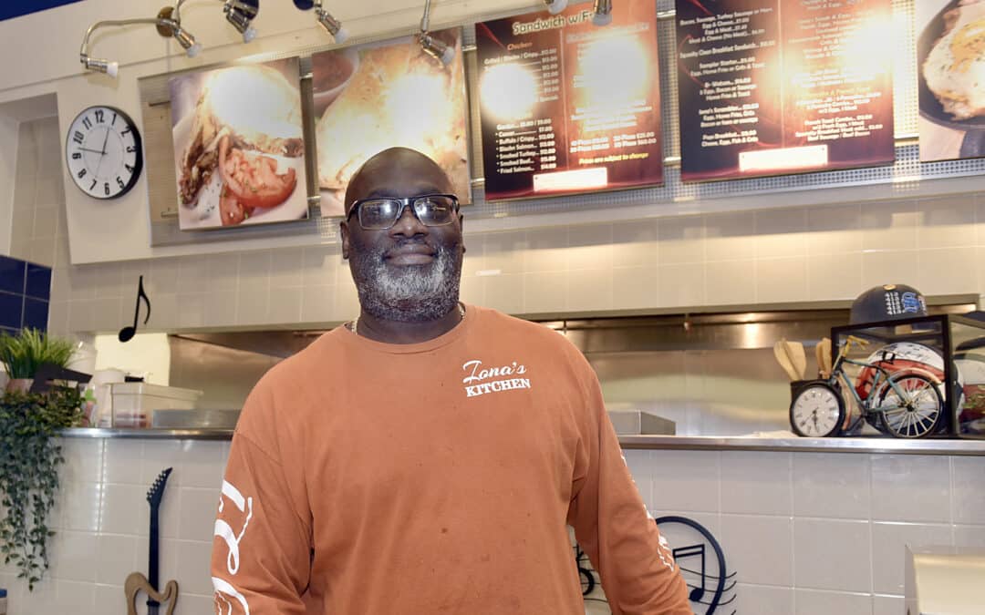 Restaurant owner distributing hot free meals to those in need