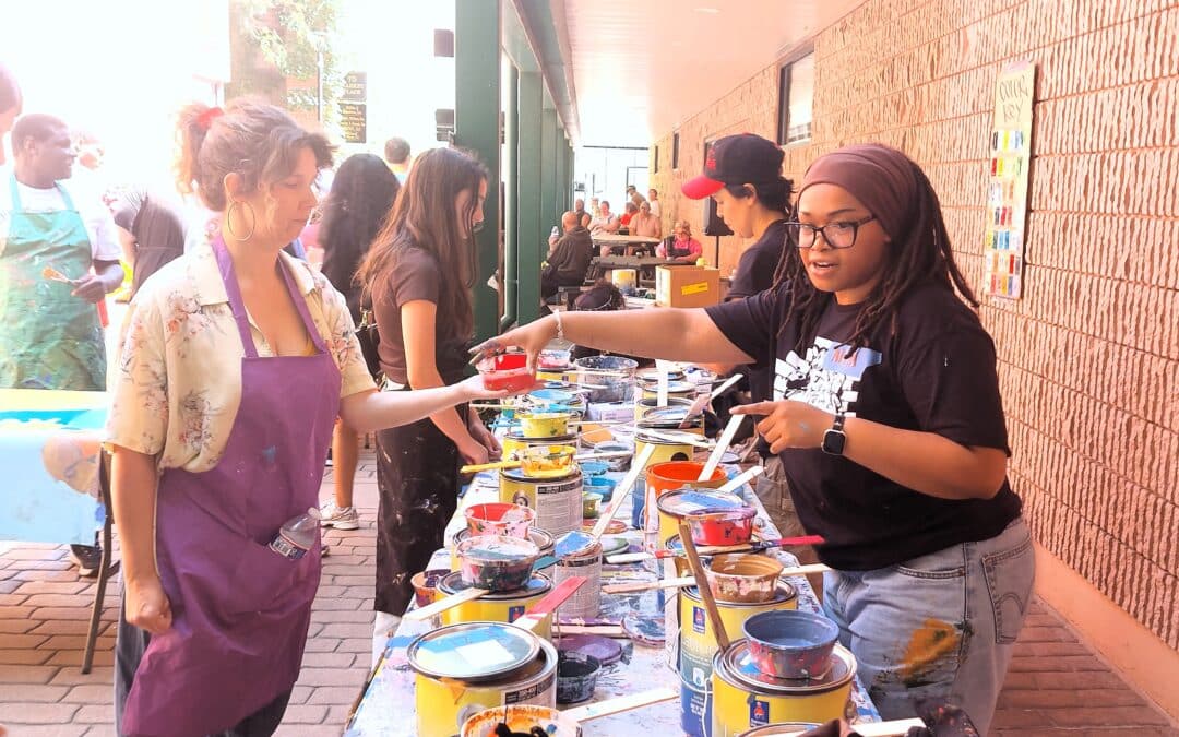 People get hands on to create mural of organization’s history